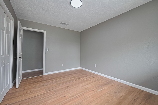 11903 Atwell Dr, Houston, TX 77035 - unfurnished room featuring light wood-style flooring, baseboards, and a textured ceiling