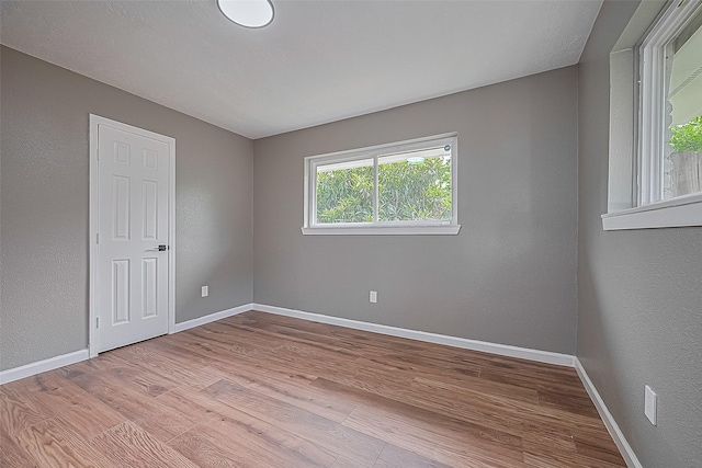 11903 Atwell Dr, Houston, TX 77035 - empty room with wood finished floors, baseboards, and a textured wall