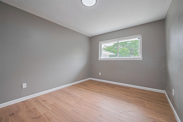 11903 Atwell Dr, Houston, TX 77035 - spare room with light wood-style flooring, baseboards, a textured ceiling, and a textured wall