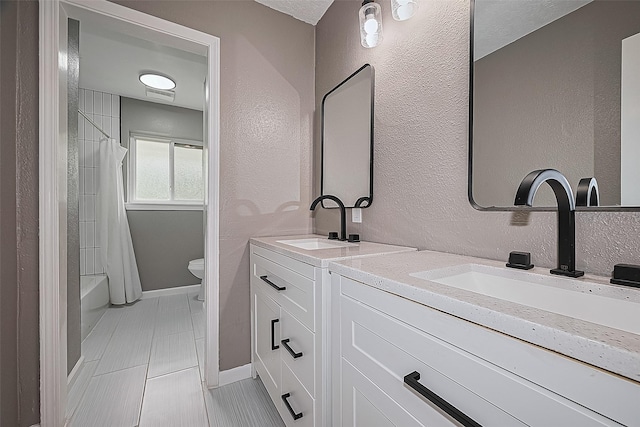11903 Atwell Dr, Houston, TX 77035 - full bathroom featuring double vanity, toilet, a textured wall, tile patterned flooring, and shower / bathtub combination with curtain