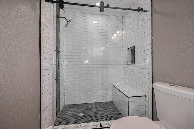 11903 Atwell Dr, Houston, TX 77035 - bathroom with a textured wall, toilet, and a shower stall