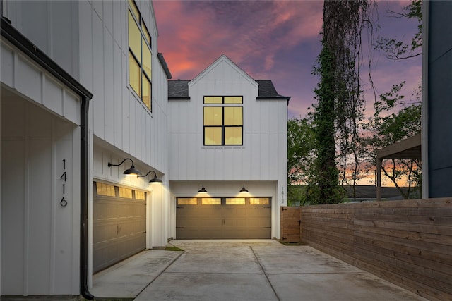 1412 Weiss St, Houston, TX 77009 - garage at dusk with driveway and fence