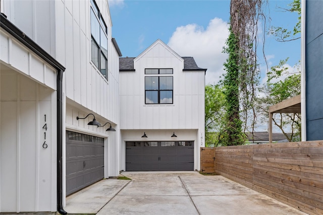 1412 Weiss St, Houston, TX 77009 - garage featuring concrete driveway and fence