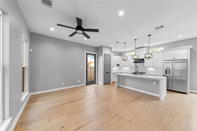 1412 Weiss St, Houston, TX 77009 - kitchen featuring stainless steel fridge with ice dispenser, light countertops, ceiling fan, recessed lighting, and backsplash
