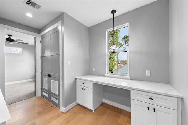 1412 Weiss St, Houston, TX 77009 - unfurnished office featuring light wood-type flooring, baseboards, a ceiling fan, and built in desk