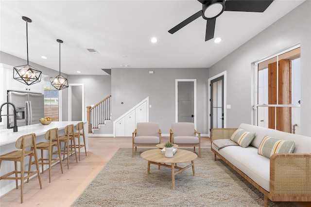 1412 Weiss St, Houston, TX 77009 - living area featuring stairs, light wood-style floors, recessed lighting, a ceiling fan, and baseboards