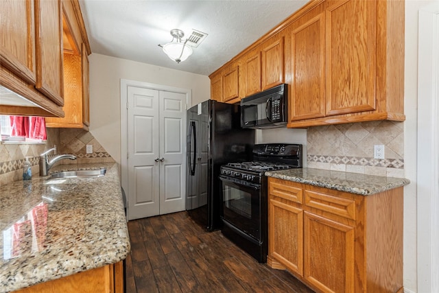 1705 Bimini Way, Seabrook, TX 77586 - kitchen featuring black appliances, a sink, dark wood-type flooring, backsplash, and light stone countertops