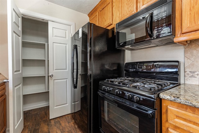 1705 Bimini Way, Seabrook, TX 77586 - kitchen featuring black appliances, dark wood finished floors, tasteful backsplash, brown cabinetry, and light stone counters