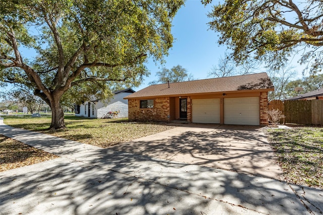1705 Bimini Way, Seabrook, TX 77586 - view of front of house with an attached garage, concrete driveway, brick siding, and a shingled roof