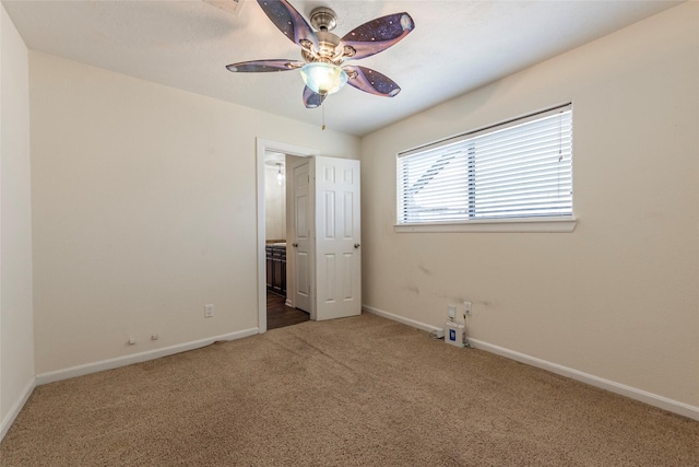 1705 Bimini Way, Seabrook, TX 77586 - unfurnished bedroom with carpet floors, baseboards, ensuite bathroom, and ceiling fan