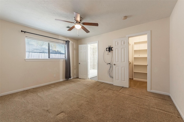 1705 Bimini Way, Seabrook, TX 77586 - unfurnished bedroom with a walk in closet, carpet flooring, baseboards, ensuite bath, and a closet