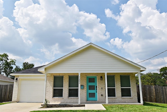 1202 Fort St, Richmond, TX 77469 - view of front of house with a porch, concrete driveway, an attached garage, and brick siding