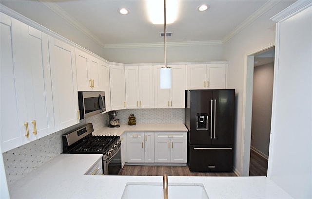 1202 Fort St, Richmond, TX 77469 - kitchen with appliances with stainless steel finishes, a sink, ornamental molding, white cabinetry, and light countertops