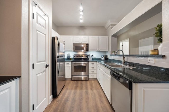 3231 Allen Pkwy Unit 6106, Houston, TX 77019 - kitchen with stainless steel appliances, a sink, white cabinets, and wood finished floors