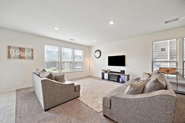 17303 Rock Willow Ln, Tomball, TX 77377 - living area with recessed lighting, baseboards, tile patterned flooring, and a textured ceiling