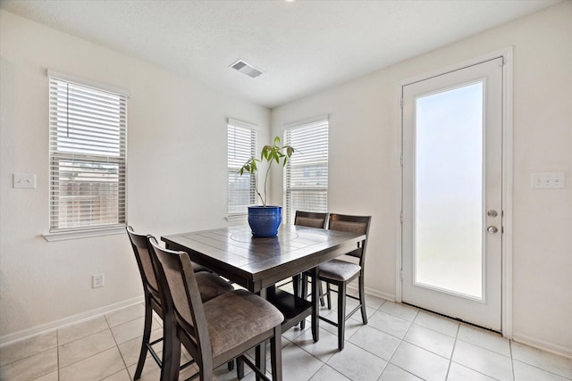 17303 Rock Willow Ln, Tomball, TX 77377 - dining room with baseboards and light tile patterned floors
