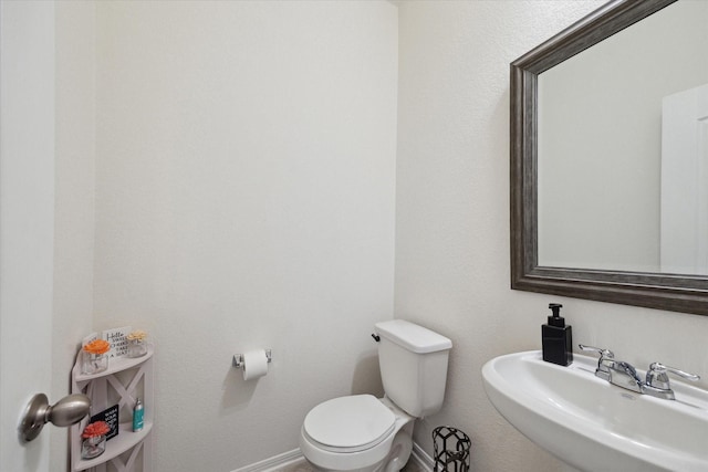 17303 Rock Willow Ln, Tomball, TX 77377 - half bathroom with toilet, a sink, and baseboards