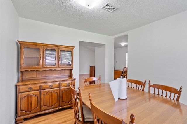 4801 36th St, Dickinson, TX 77539 - dining area with a textured ceiling and light wood-style floors