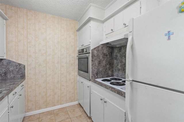 4801 36th St, Dickinson, TX 77539 - kitchen featuring white appliances, wallpapered walls, white cabinets, a textured ceiling, and baseboards