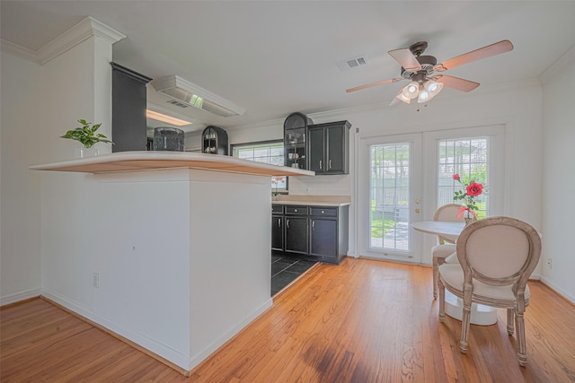3042 Oak Forest Dr, Houston, TX 77018 - kitchen featuring wood finished floors, a ceiling fan, crown molding, baseboards, and light countertops