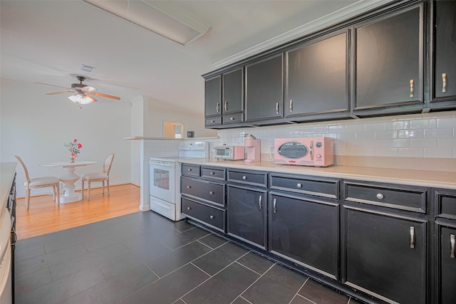 3042 Oak Forest Dr, Houston, TX 77018 - kitchen featuring white appliances, a ceiling fan, backsplash, light countertops, and dark tile patterned flooring
