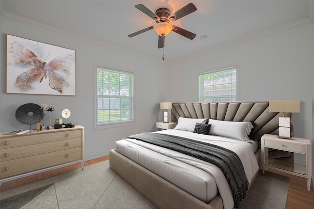 3042 Oak Forest Dr, Houston, TX 77018 - bedroom featuring light wood finished floors, multiple windows, crown molding, ceiling fan, and baseboards