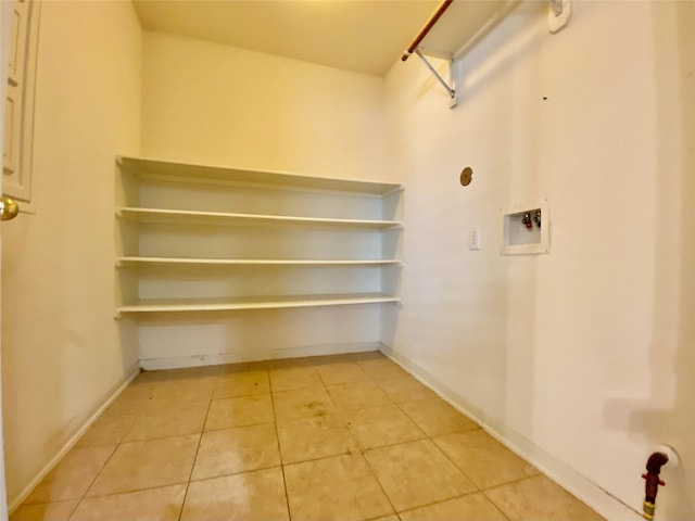 9414 Glendown Ln, Houston, TX 77070 - clothes washing area with light tile patterned flooring, washer hookup, and baseboards