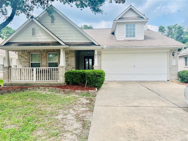 9414 Glendown Ln, Houston, TX 77070 - view of front facade featuring a porch, an attached garage, concrete driveway, and brick siding