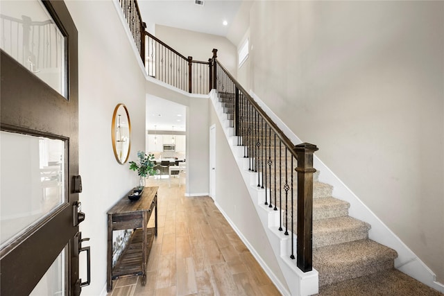 17814 Tree Of Heaven, Conroe, TX 77385 - stairs with a towering ceiling, wood finished floors, and baseboards