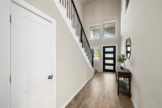 17814 Tree Of Heaven, Conroe, TX 77385 - foyer with baseboards, wood finished floors, stairway, and a towering ceiling