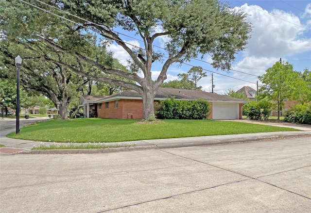 3641 Deal St, Houston, TX 77025 - view of front facade with concrete driveway, a front lawn, an attached garage, and brick siding