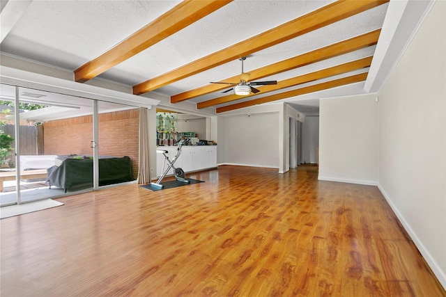 3641 Deal St, Houston, TX 77025 - unfurnished living room with ceiling fan, wood finished floors, baseboards, and a textured ceiling