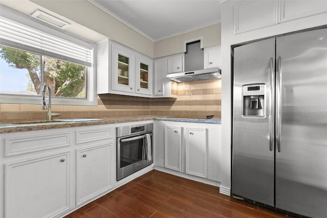 3641 Deal St, Houston, TX 77025 - kitchen with stainless steel appliances, a sink, ornamental molding, white cabinetry, and dark wood-type flooring