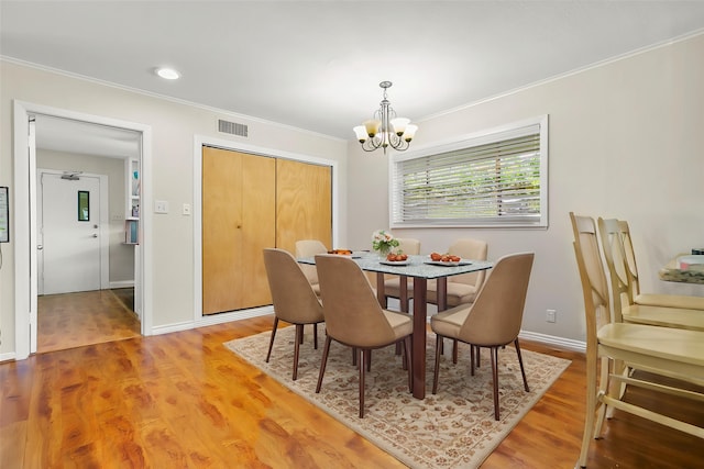 3641 Deal St, Houston, TX 77025 - dining area with a chandelier, ornamental molding, light wood-type flooring, and baseboards