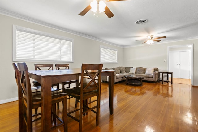 3641 Deal St, Houston, TX 77025 - dining space with ceiling fan, crown molding, hardwood / wood-style flooring, and baseboards