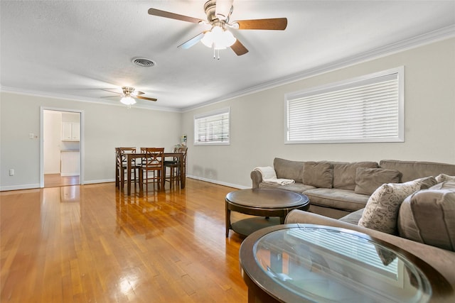 3641 Deal St, Houston, TX 77025 - living area featuring a ceiling fan, ornamental molding, light wood finished floors, and baseboards