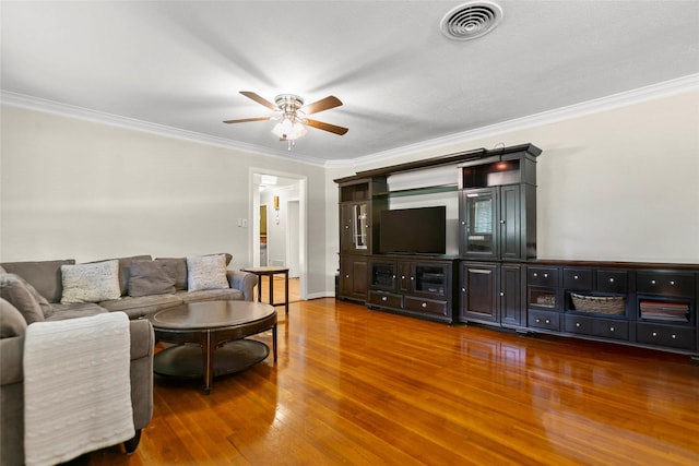 3641 Deal St, Houston, TX 77025 - living area with a ceiling fan, ornamental molding, wood finished floors, and baseboards