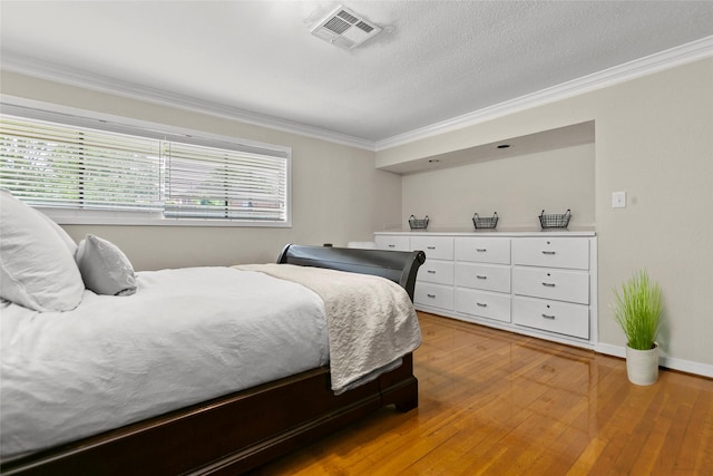 3641 Deal St, Houston, TX 77025 - bedroom with crown molding, light wood-style floors, and baseboards