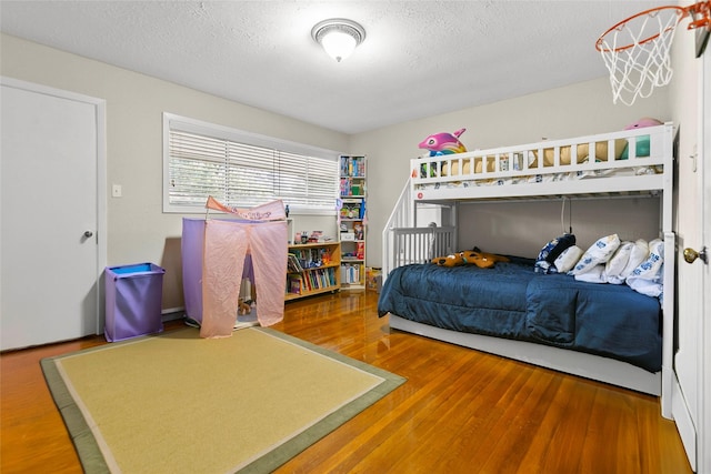 3641 Deal St, Houston, TX 77025 - bedroom featuring wood finished floors and a textured ceiling