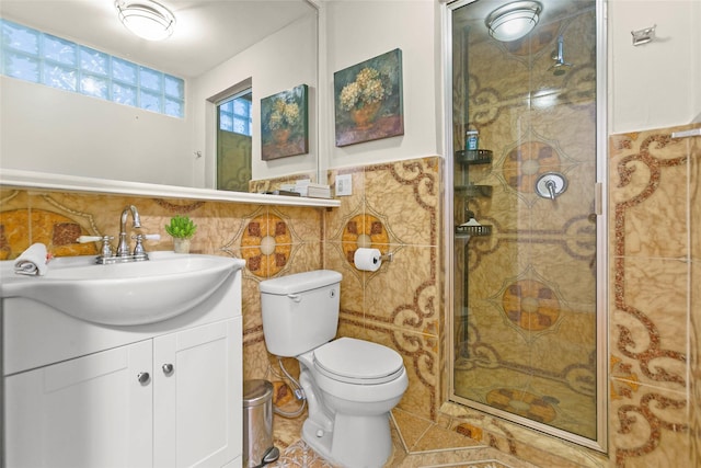 3641 Deal St, Houston, TX 77025 - bathroom with tile walls, a stall shower, vanity, toilet, and a wainscoted wall