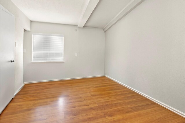 3641 Deal St, Houston, TX 77025 - unfurnished room featuring beam ceiling, wood finished floors, and baseboards
