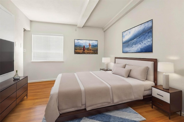 3641 Deal St, Houston, TX 77025 - bedroom featuring beamed ceiling, light wood-style floors, and baseboards