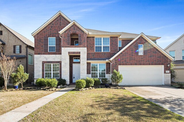4663 Rockton Hills Ln, Sugar Land, TX 77479 - view of front facade with stone siding, driveway, and a garage