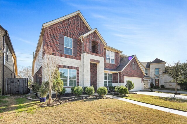 4663 Rockton Hills Ln, Sugar Land, TX 77479 - view of front of house featuring driveway, brick siding, and stone siding