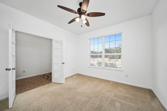 4663 Rockton Hills Ln, Sugar Land, TX 77479 - unfurnished bedroom featuring carpet floors, baseboards, french doors, ceiling fan, and lofted ceiling