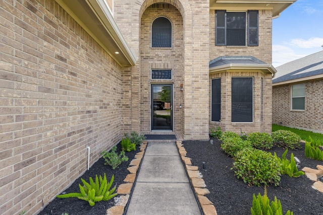 property entrance with brick siding