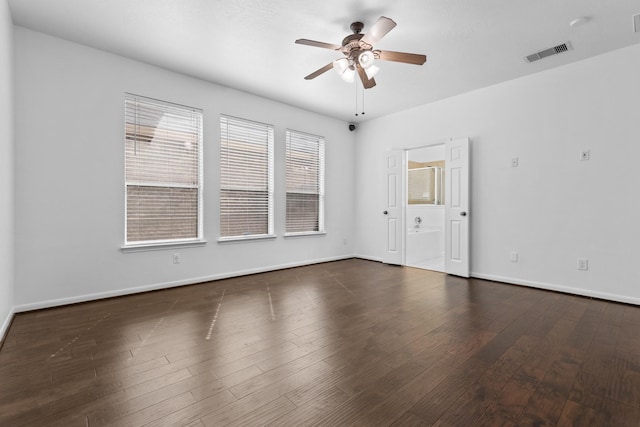 spare room with a ceiling fan, baseboards, and wood finished floors