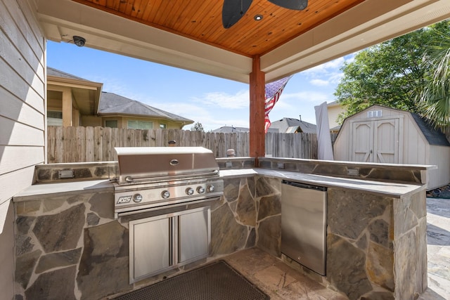view of patio with area for grilling, a grill, fence, and a storage shed