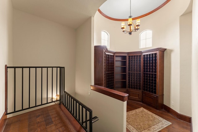 8111 Marshall Falls Dr, Spring, TX 77379 - stairway featuring a chandelier, wood finished floors, and baseboards