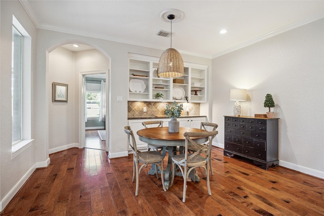 6338 Collina Springs Ct, Houston, TX 77041 - dining area featuring dark wood finished floors, arched walkways, crown molding, baseboards, and recessed lighting